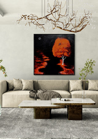 Red Tree by Moonlight by Marcel Herrmann in a black frame above a cream sofa under a branch chandelier