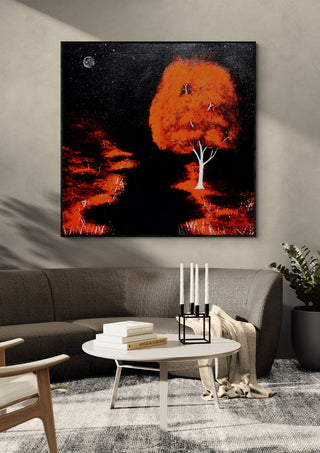 Red Tree by Moonlight by Marcel Herrmann in a black frame above a dark sofa with candlesticks on a round table