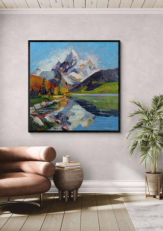 Still Waters, Endless Peaks by Evgenia Smirnova in a black frame above a leather armchair beside a palm
