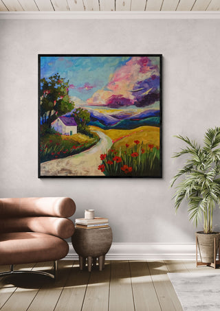 A Place to Return To by Evgenia Smirnova in a black frame above a leather armchair beside a palm