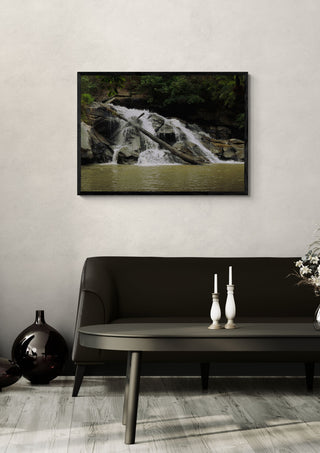 Doi Inthanon by Elefteria in a black frame above a dark sofa with candlesticks on a round table
