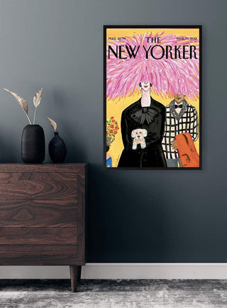Framed Pink Hair Plakat on a dark wall above a wooden dresser with vases and dried foliage.