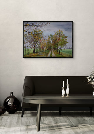 Autumn in Mecklenburg by Juergen Duerrmann in a black frame above a dark sofa with candlesticks on a round table