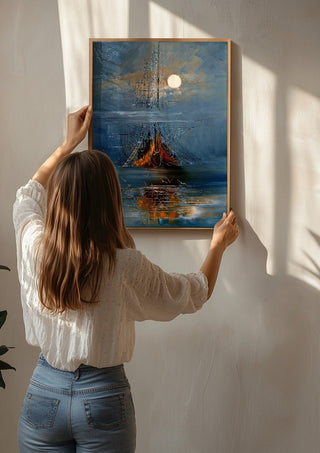 Moon over the Ship by Justyna Kopania being hung on a sunlit wall