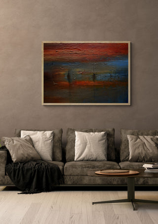 Red Horizon by Justyna Kopania in a light oak frame above a grey sofa on a warm brown wall