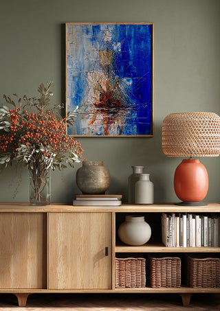 Ship in Blue by Justyna Kopania above a wooden sideboard on a sage green wall