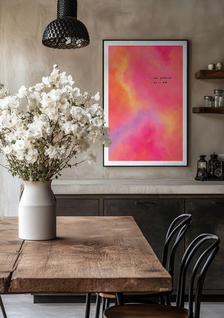 I Am Enough by Decker Studios in a black frame above a rustic table with white flowers