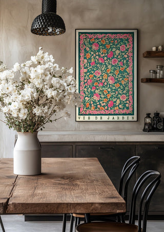 Vie de Jardin by Annika Persson in a black frame above a rustic table with white flowers