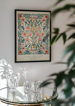 FLEUR PRÉCIEUES by Annika Persson in a black frame above a glass table with crystal glassware