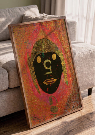 GOA by Ali Kasap in a walnut frame leaning against a grey sofa