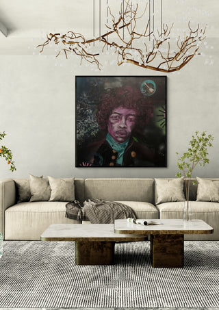 Jimi Hendrix by creatievananne in a black frame above a cream sofa under a branch chandelier