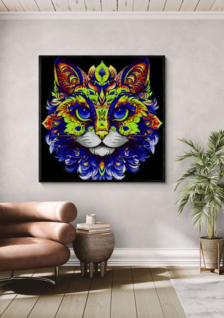 The Ornamental Cat by BunteBeute in a black frame above a leather armchair beside a palm