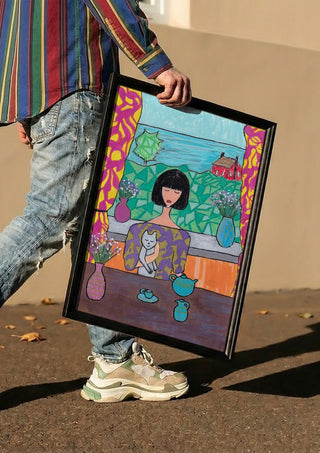 Tea by the Sea by Camilla Nilsson carried in a black frame along a sunny street