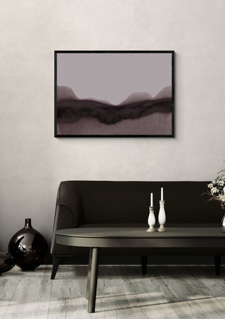 abstract moody landscape by Iris Lehnhardt in a black frame above a dark sofa with candlesticks on a round table