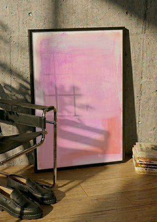 soft atmospheric colorfields by Iris Lehnhardt in a black frame leaning against a concrete wall by a steel chair