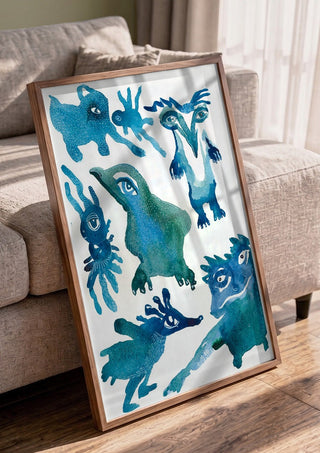 Creatures by Lena Galé in a walnut frame leaning against a grey sofa