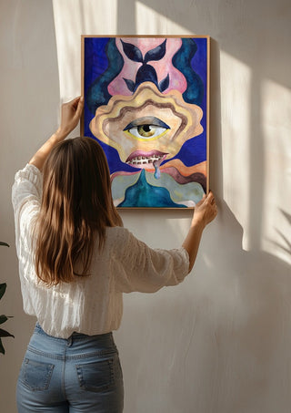 The Weeping Eye by Shimmering Ugly being hung on a sunlit wall
