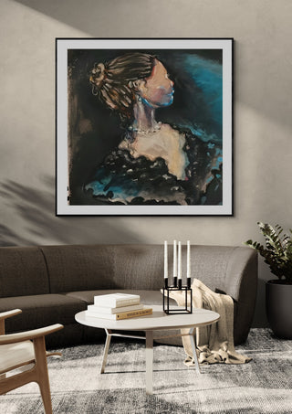 The Rich Lady by Christin in a black frame above a grey sofa with a round coffee table