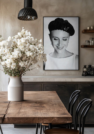 The French girl by Bettinafloorphoto in a black frame above a rustic table with white flowers