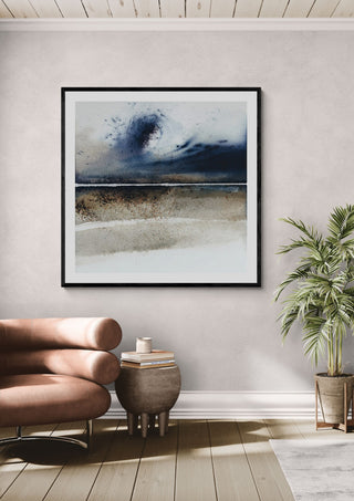 A wave from the past by Tania Zubareva in a black frame above a leather armchair beside a potted palm