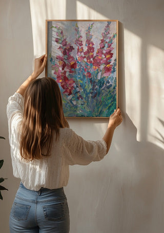 Red Snapdragon Flowers by DNF being hung on a sunlit wall