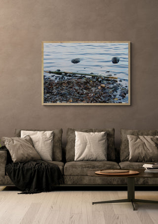 Sjöns puls by Ljilja Marinic in a light oak frame on a warm grey wall above a brown sofa