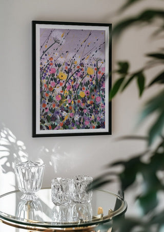 Silver street by Rebecca Wright in a black frame above a glass table with crystal glassware
