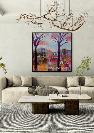 Busy and happy by María Burgaz in a black frame above a beige sofa under a branch chandelier