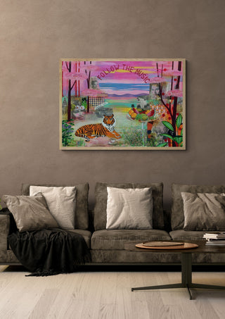 Follow the music by María Burgaz in a light oak frame on a warm grey wall above a brown sofa