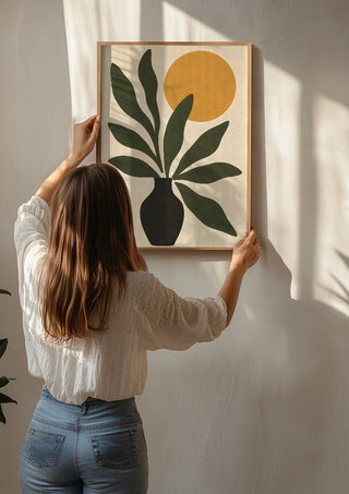 Minimalist Botanical Still Life with Sun by TimlessArtworks being hung on a sunlit wall