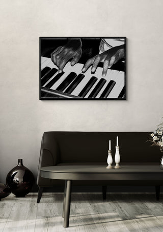 Black and White by Massimo Frascogna in a black frame on a pale wall above a dark sofa with candlesticks