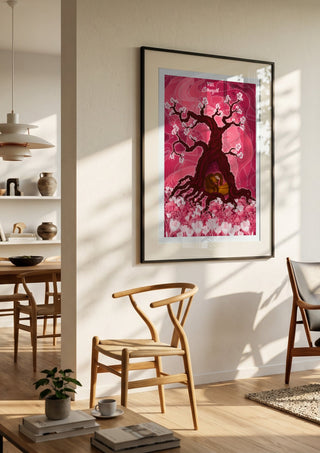 The Strength by Sciurus tarotus in a black frame in a bright dining room with wooden chairs