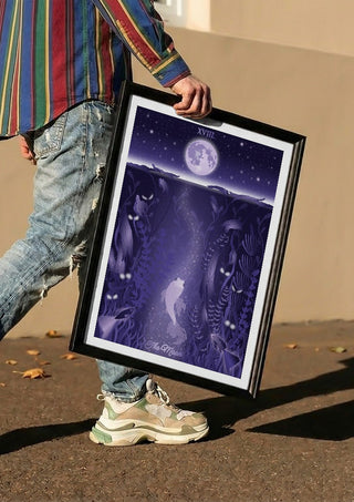 The Moon by Sciurus tarotus carried in a black frame along a sunny street
