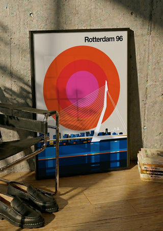 Rotterdam 96 by Bo Lundberg in a black frame leaning against a concrete wall by a steel chair