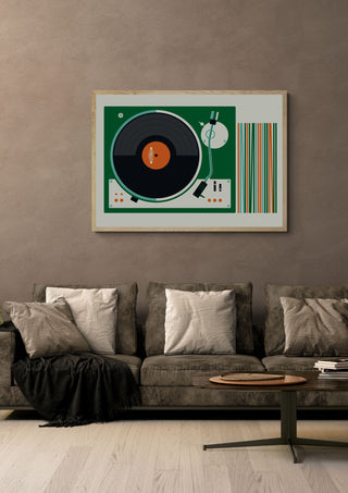Record Player by Bo Lundberg in a light oak frame on a warm grey wall above a brown sofa