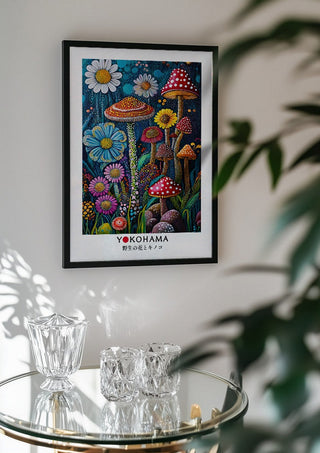 Wild Flowers and Mushrooms by Yokohama in a black frame above a glass table with crystal glassware