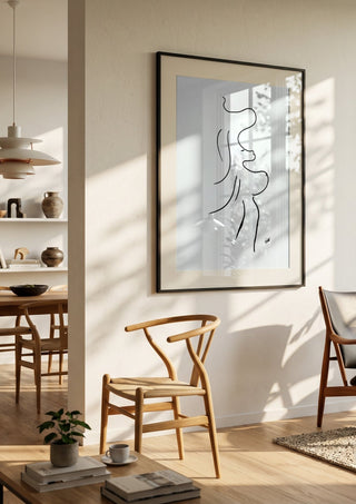 I am move by FridaRit in a black frame in a bright dining room with wooden chairs