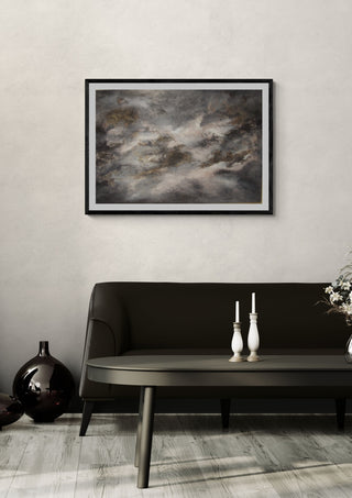 Skuggornas dans by Ljilja Marinic in a black frame on a pale wall above a dark sofa with candlesticks