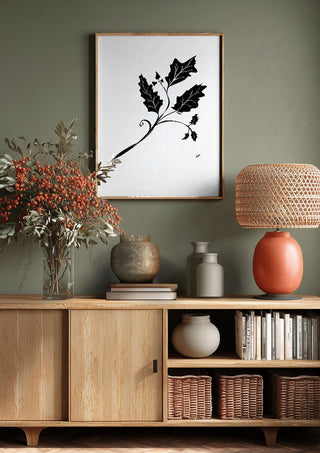 Leife by FridaRit above a wooden sideboard on a sage green wall