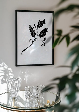 Leife by FridaRit in a black frame above a glass table with crystal glassware