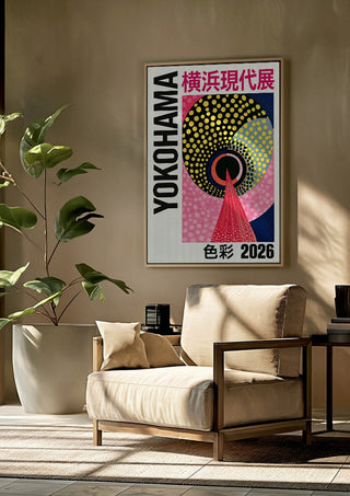Circles and Colour by Yokohama framed above a beige armchair beside a potted plant