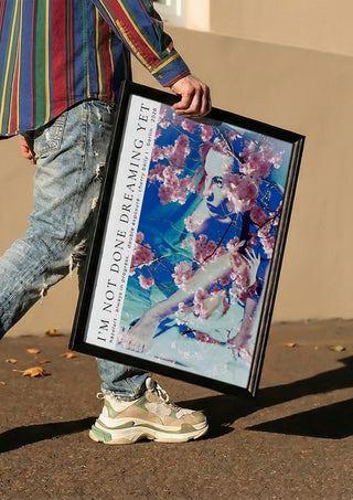 cherry baily by hazelart carried in a black frame along a sunny street