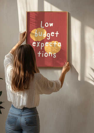 Low Budget Expectations by Jakob Falkenberg being hung on a sunlit wall