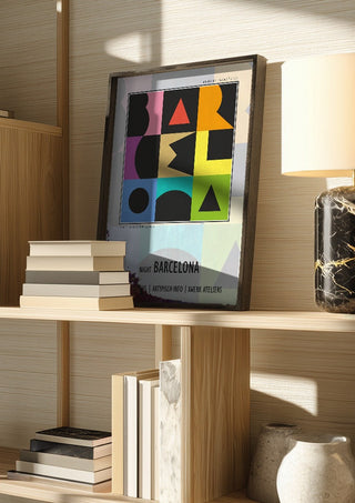 Night Barcelona - Term Signal by Amadeus Fuchs in a dark frame on a wooden shelf beside books and a lamp