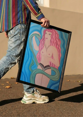 Eva in Paradise by Carmen Coduri carried in a black frame along a sunny street