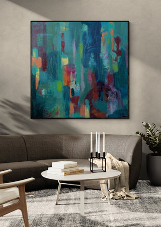 Beginnings by Janet Bell in a black frame on a grey wall above a dark sofa with candlesticks