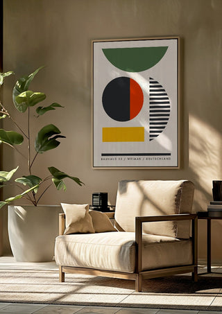 Bauhaus Shapes by Neil Stevens framed above a beige armchair beside a potted plant