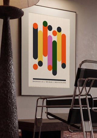 Bauhaus Columns by Neil Stevens framed in a dim room beside a tubular steel chair