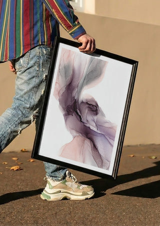 Spring Melody by Anna Dormir carried in a black frame along a sunny street