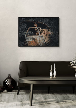 Decay (4) by Lone Gjessing in a black frame on a pale wall above a dark sofa with candlesticks